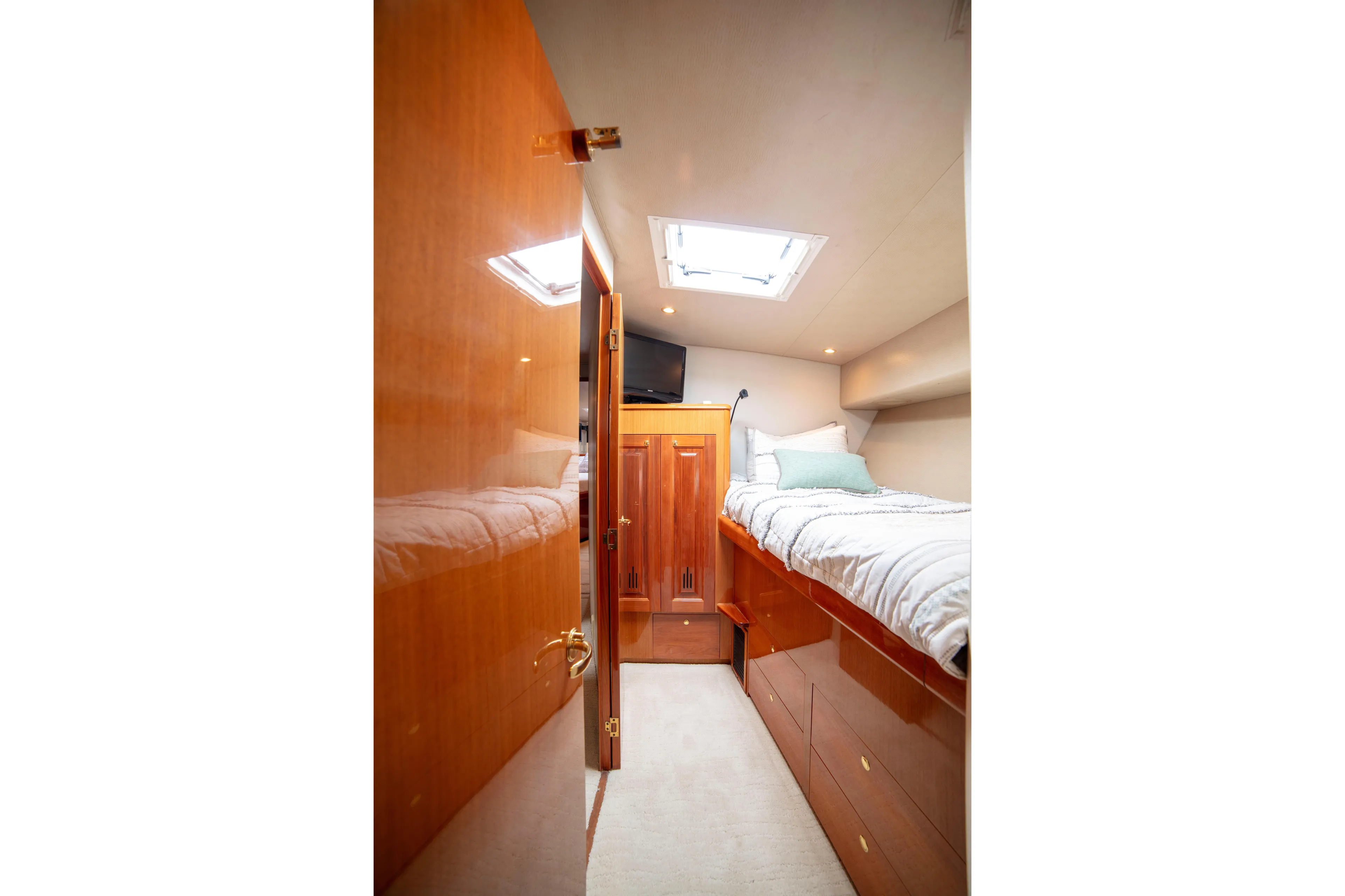 Prime Time Yacht Photos Pics Cozy cabin interior of 2002 Viking 65 Enclosed Bridge yacht with wooden finishes.