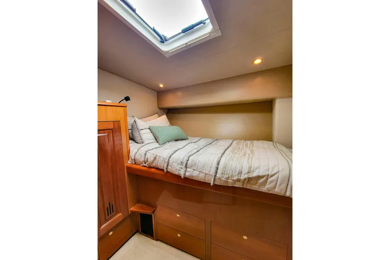 Prime Time Yacht Photos Pics Cozy cabin interior of 2002 Viking 65 Enclosed Bridge yacht with skylight and bedding.