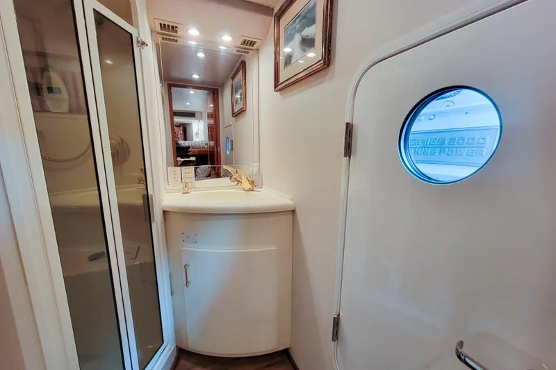 Prime Time Yacht Photos Pics Bathroom interior of 2002 Viking 65 Enclosed Bridge yacht with shower and vanity.