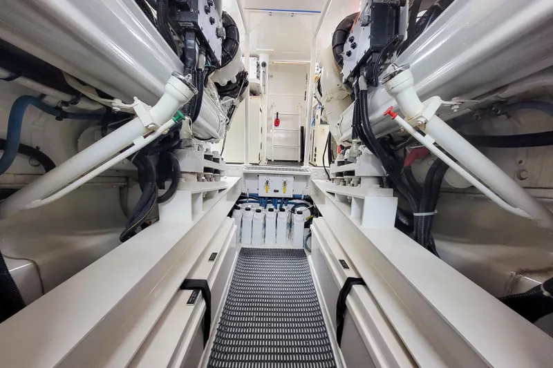 Prime Time Yacht Photos Pics Engine room of 2002 Viking 65 Enclosed Bridge yacht, showcasing mechanical components and systems.