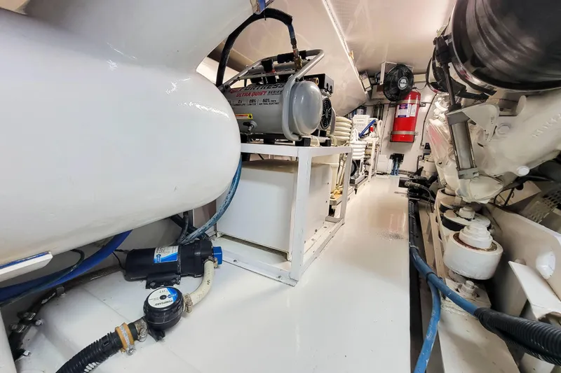Prime Time Yacht Photos Pics Engine room of 2002 Viking 65 Enclosed Bridge yacht, featuring mechanical equipment and piping.