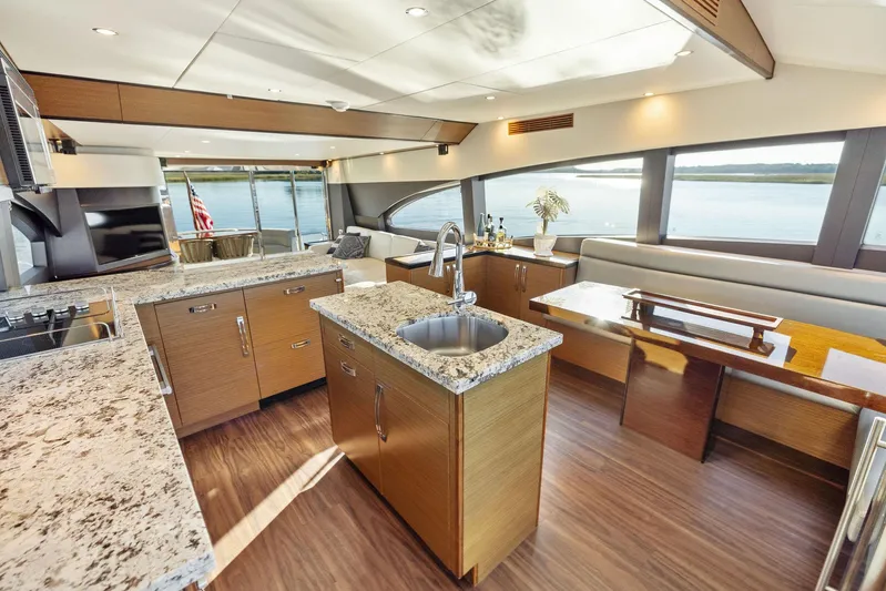 Bonefish Yacht Photos Pics Luxurious 2016 Hatteras M60 yacht interior with modern kitchen and dining area.