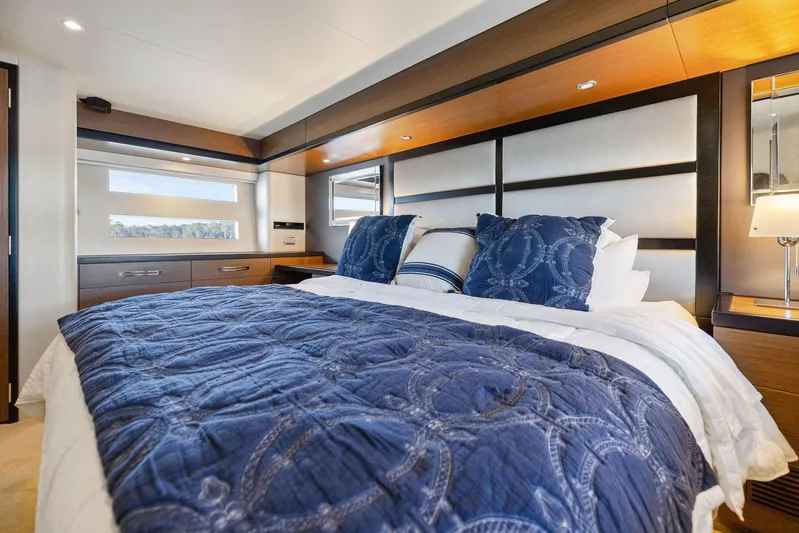 Bonefish Yacht Photos Pics Luxurious bedroom interior of 2016 Hatteras M60 yacht with elegant bedding and modern design.