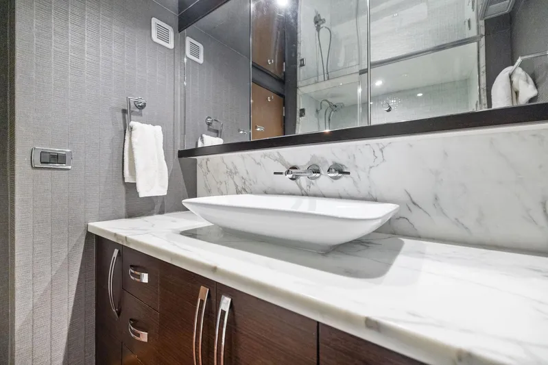 Bonefish Yacht Photos Pics Luxurious bathroom in 2016 Hatteras M60 yacht with marble countertop and modern sink.