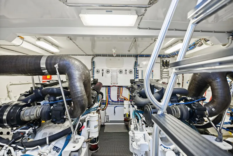 Bonefish Yacht Photos Pics Engine room of 2016 Hatteras M60 yacht, showcasing dual engines and intricate piping.