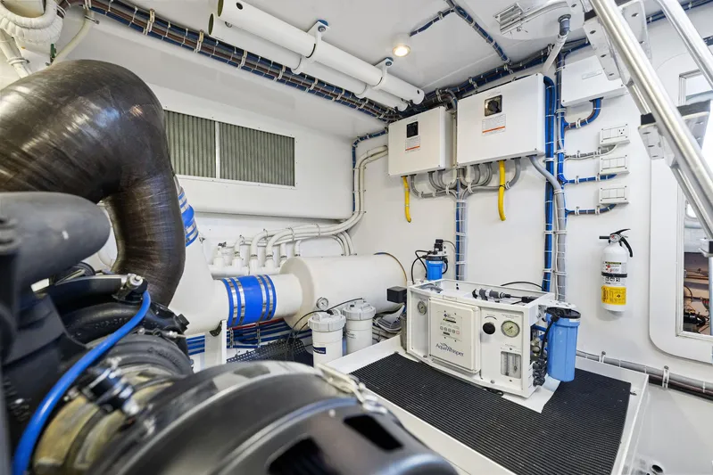 Bonefish Yacht Photos Pics Engine room of 2016 Hatteras M60 yacht, showcasing advanced machinery and equipment.