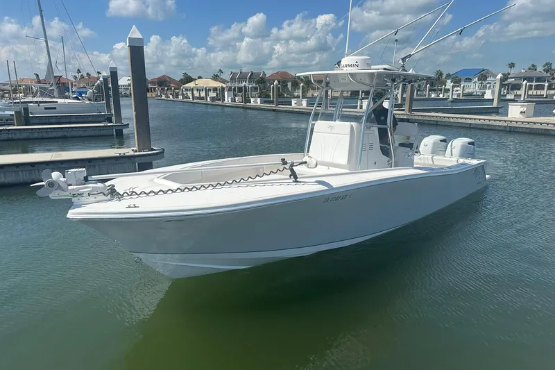 Cherokee Yacht Photos Pics 2022 Ocean Runner 29 Center Console boat docked in a marina under a clear sky.