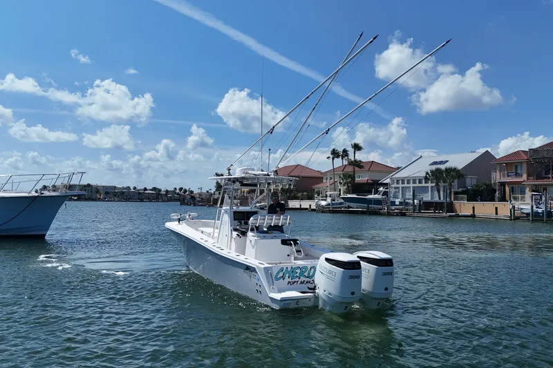 Cherokee Yacht Photos Pics 2022 Ocean Runner 29 Center Console boat on water, sunny day, coastal homes in background.