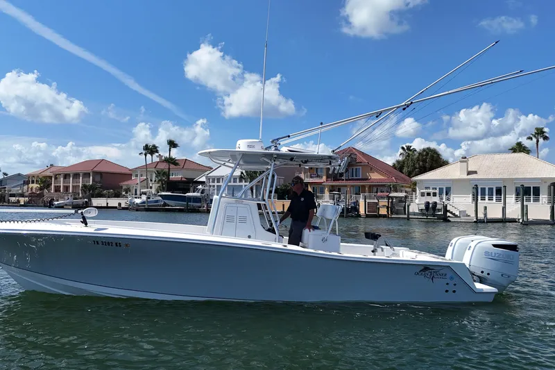 Cherokee Yacht Photos Pics 2022 Ocean Runner 29 Center Console boat on water, with coastal homes in the background.
