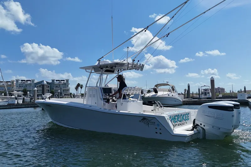 Cherokee Yacht Photos Pics 2022 Ocean Runner 29 Center Console boat docked in marina under blue sky.