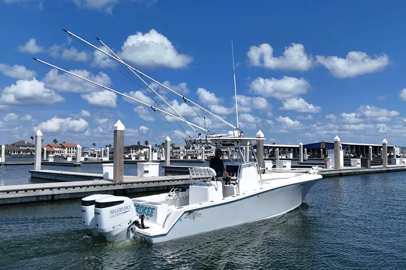 Cherokee Yacht Photos Pics 2022 Ocean Runner 29 Center Console boat in marina, clear sky, calm water.