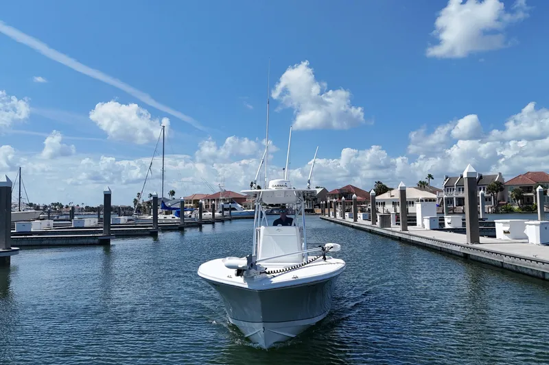 Cherokee Yacht Photos Pics 2022 Ocean Runner 29 Center Console boat in a marina under a clear blue sky.