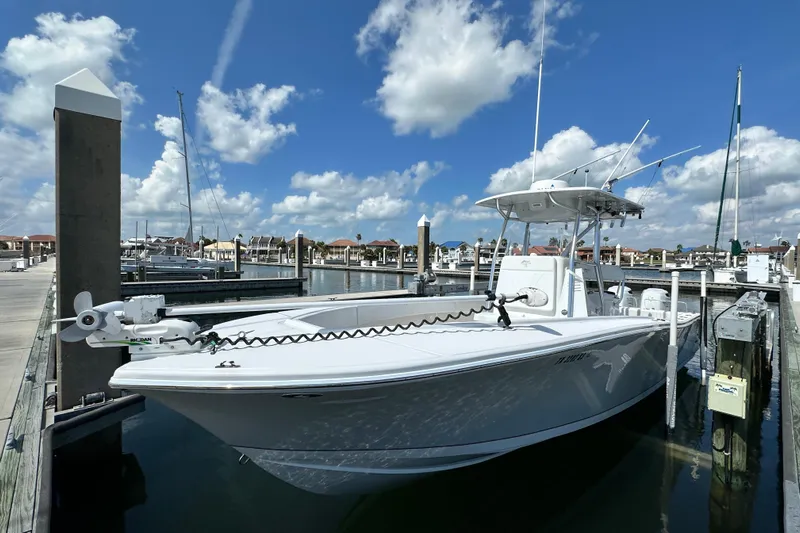 Cherokee Yacht Photos Pics 2022 Ocean Runner 29 Center Console boat docked at marina under blue sky.