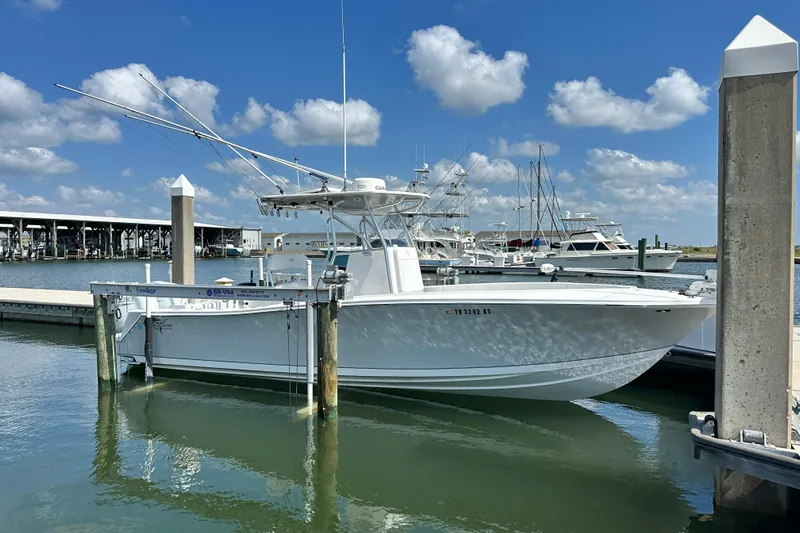 Cherokee Yacht Photos Pics 2022 Ocean Runner 29 Center Console boat docked at marina under blue sky.