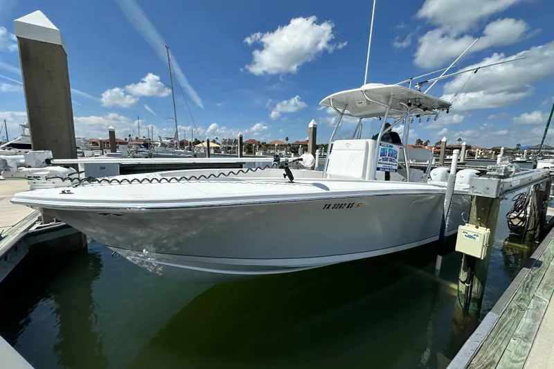 Cherokee Yacht Photos Pics 2022 Ocean Runner 29 Center Console boat docked at marina under blue sky.