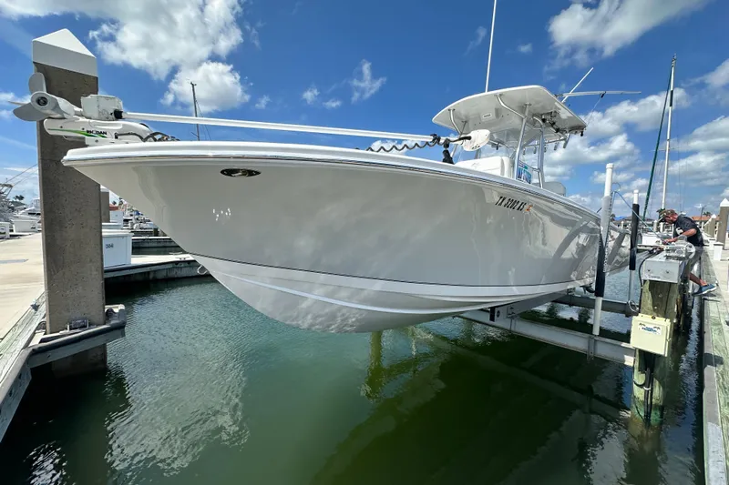Cherokee Yacht Photos Pics 2022 Ocean Runner 29 Center Console boat docked at marina under clear blue sky.