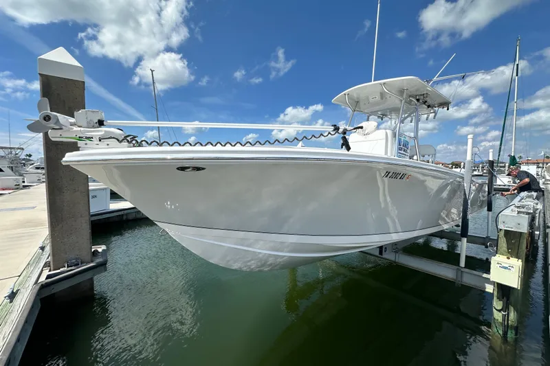 Cherokee Yacht Photos Pics 2022 Ocean Runner 29 Center Console boat docked at marina under blue sky.