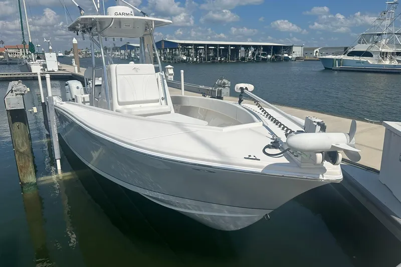 Cherokee Yacht Photos Pics 2022 Ocean Runner 29 Center Console boat docked at marina under blue sky.