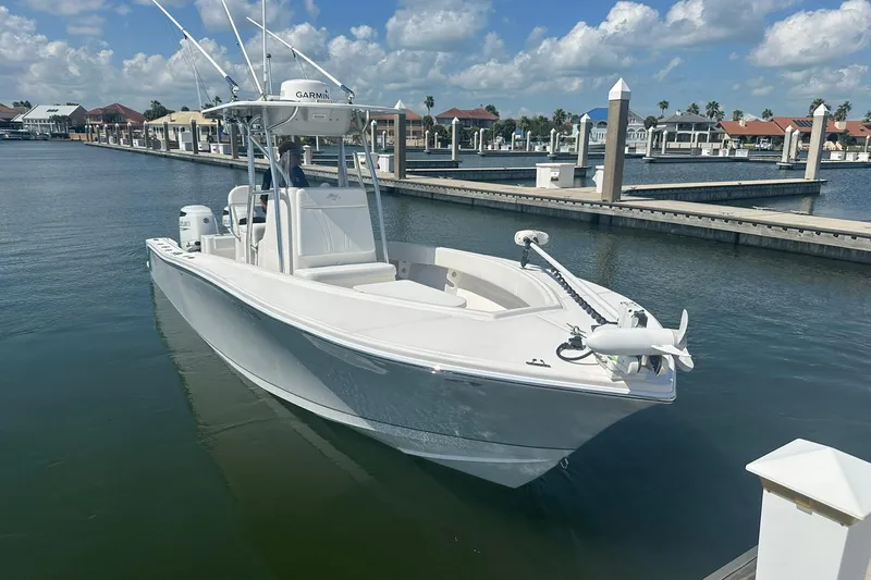 Cherokee Yacht Photos Pics 2022 Ocean Runner 29 Center Console boat docked in a marina under a blue sky.