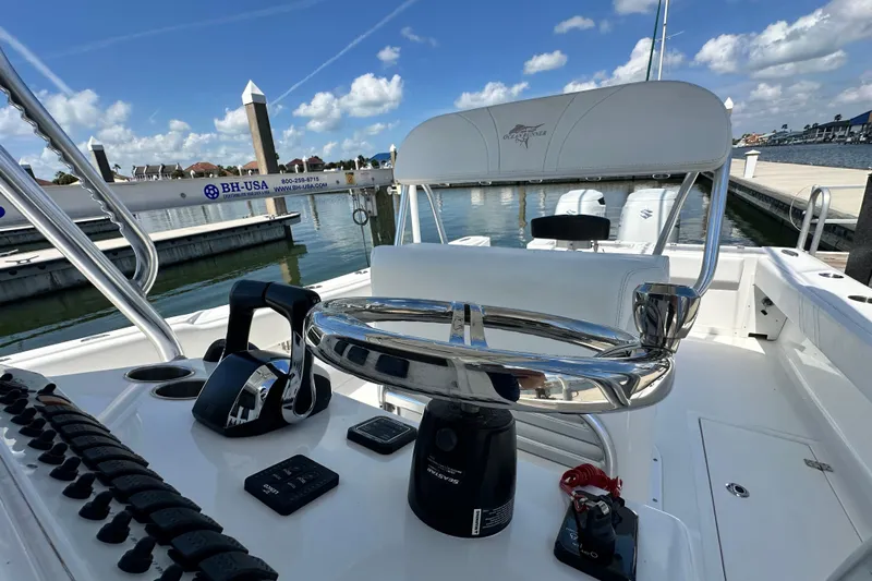 Cherokee Yacht Photos Pics 2022 Ocean Runner 29 Center Console boat at marina, featuring sleek controls and seating.