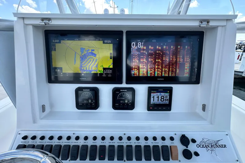 Cherokee Yacht Photos Pics 2022 Ocean Runner 29 Center Console dashboard with dual Garmin displays and Suzuki gauges.
