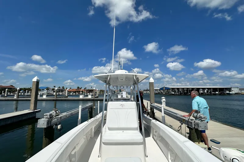 Cherokee Yacht Photos Pics 2022 Ocean Runner 29 Center Console boat docked at marina under blue sky.