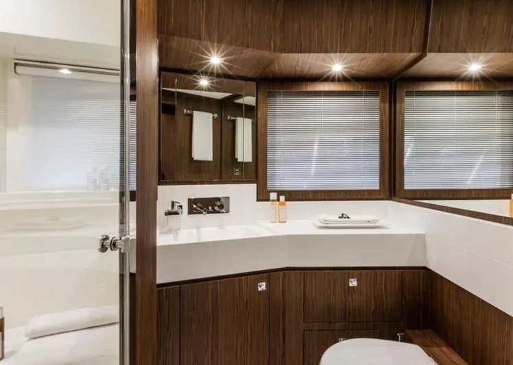  Yacht Photos Pics Luxurious bathroom interior of 2017 Riva 88' Domino Super yacht with modern wood accents.