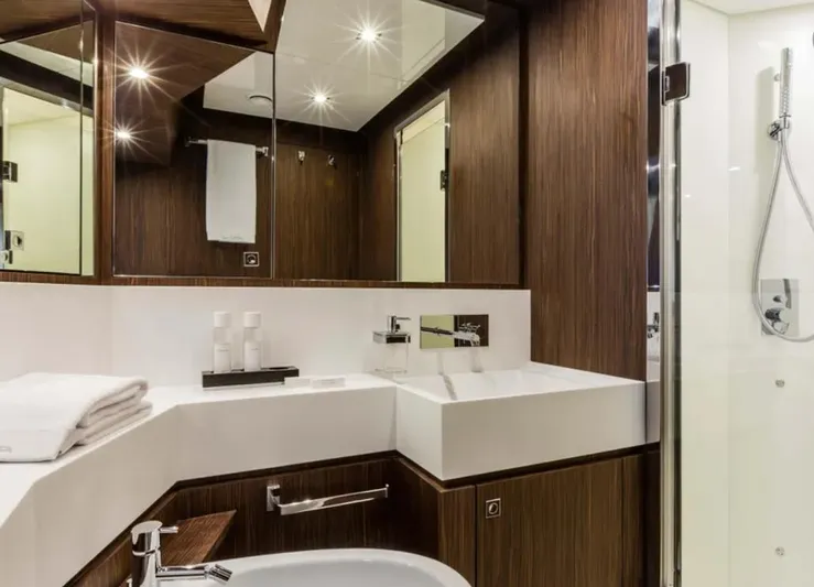  Yacht Photos Pics Luxurious bathroom in 2017 Riva 88' Domino Super yacht with modern fixtures and wood accents.
