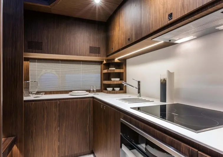  Yacht Photos Pics Luxurious kitchen interior of 2017 Riva 88' Domino Super yacht, featuring modern appliances and wood finish.