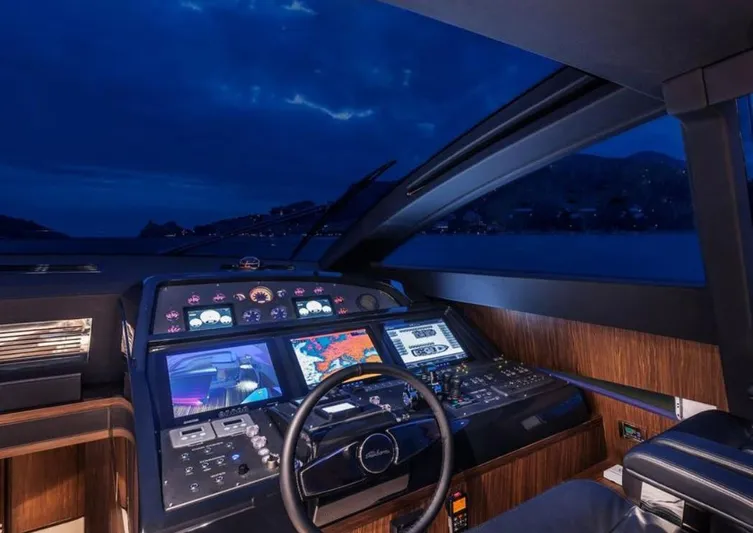  Yacht Photos Pics Cockpit of 2017 Riva 88' Domino Super yacht at night, featuring advanced navigation systems.