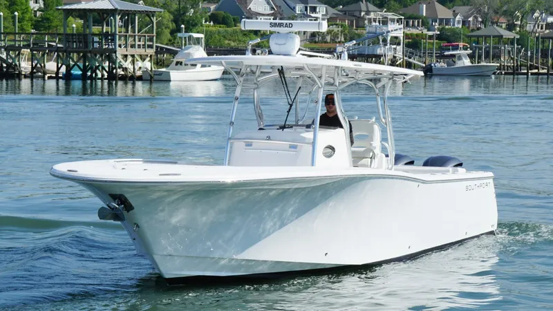  Yacht Photos Pics 2018 Southport 33 FE boat cruising in a scenic harbor setting.