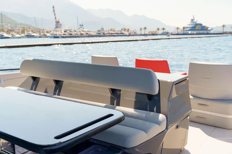  Yacht Photos Pics 2023 Anvera 48 yacht interior with seating and table, docked at a marina.