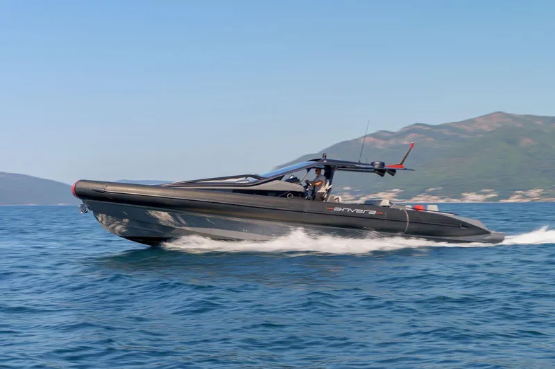  Yacht Photos Pics 2023 Anvera 48 luxury speedboat cruising on open water, scenic mountain backdrop.