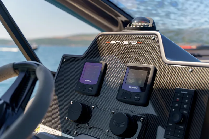  Yacht Photos Pics Dashboard of 2023 Anvera 48 boat with Yanmar displays and carbon fiber finish.