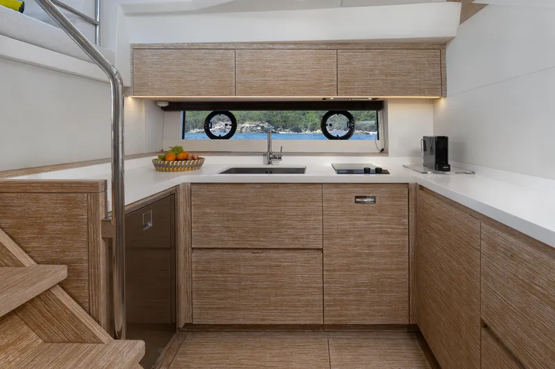 M/y Rubi Yacht Photos Pics Modern kitchen interior of 2024 Pardo Yachts GT52 with sleek wood cabinetry.