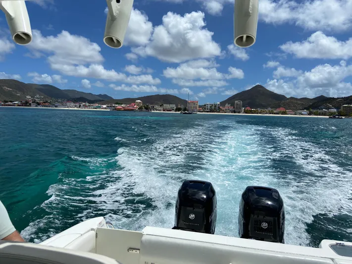 Endless Summer Yacht Photos Pics Boston Whaler 320 Outrage 2014 on open sea with coastal view.