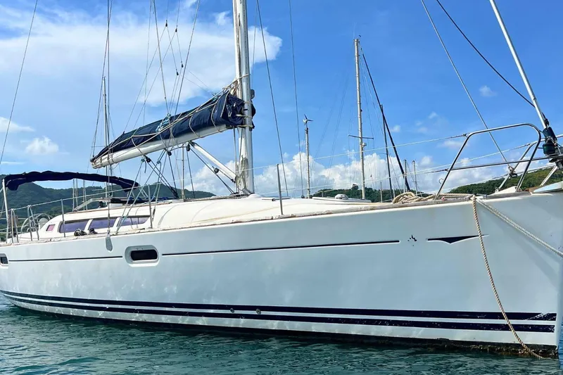  Yacht Photos Pics 2008 Jeanneau Sun Odyssey 42i Performance sailboat on calm water, clear sky background.