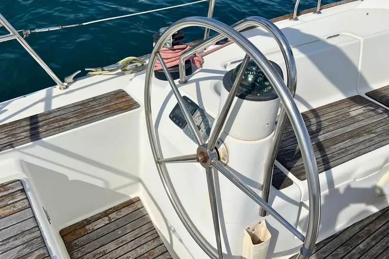  Yacht Photos Pics Steering wheel of 2008 Jeanneau Sun Odyssey 42i Performance sailboat, with wooden deck details.