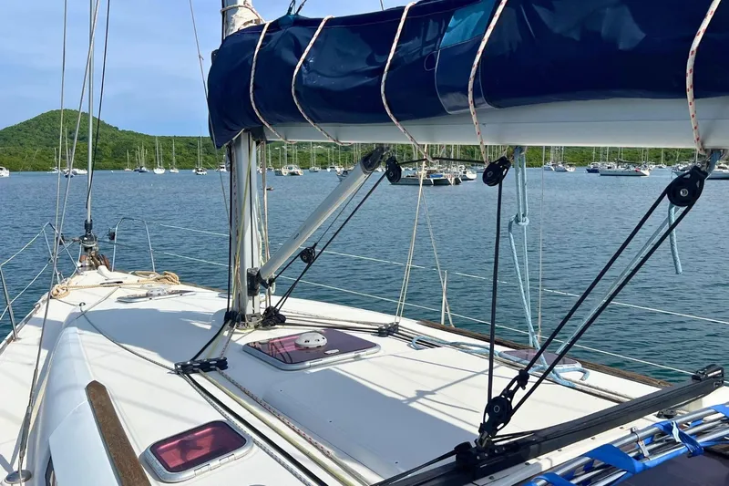  Yacht Photos Pics 2008 Jeanneau Sun Odyssey 42i Performance sailboat on calm water, surrounded by lush greenery.