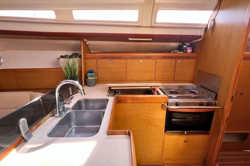  Yacht Photos Pics Interior of 2008 Jeanneau Sun Odyssey 42i Performance yacht kitchen with sink and stove.