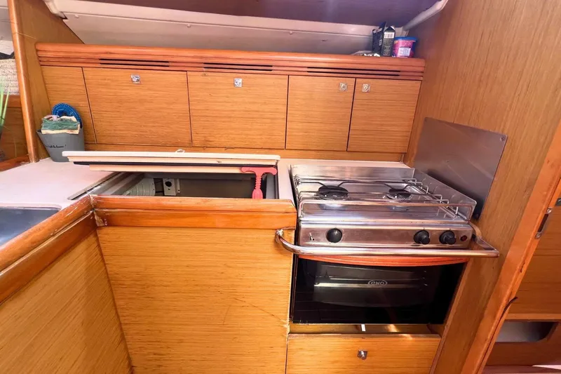 Yacht Photos Pics Galley kitchen in 2008 Jeanneau Sun Odyssey 42i Performance yacht with stove and storage.
