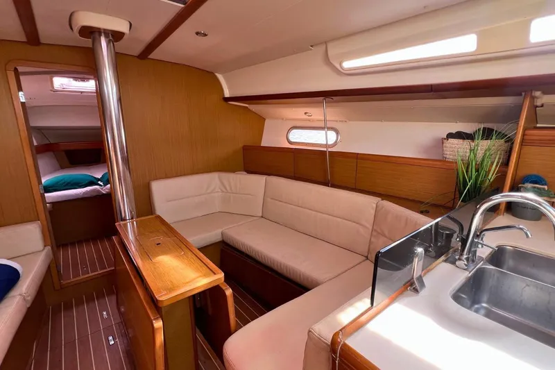  Yacht Photos Pics Interior of 2008 Jeanneau Sun Odyssey 42i Performance yacht, featuring cozy seating and modern kitchen.