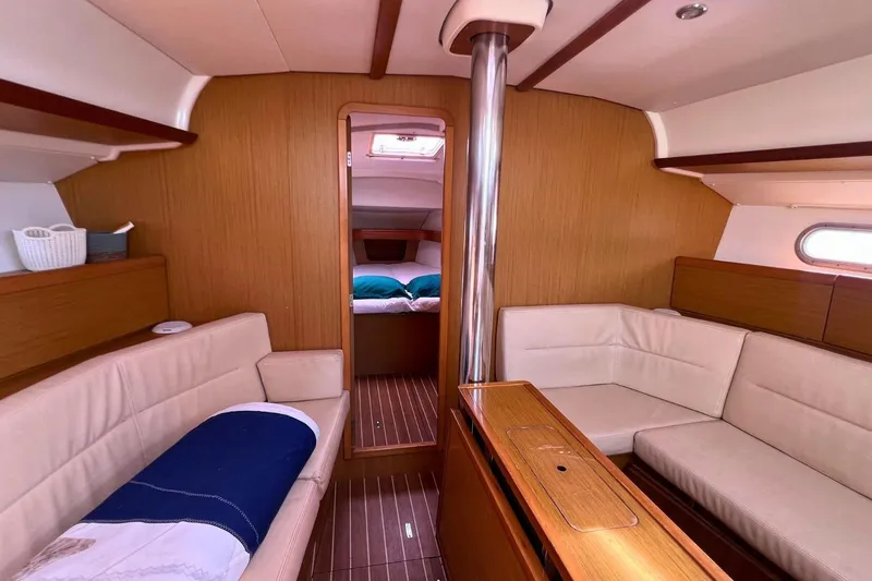  Yacht Photos Pics Interior of 2008 Jeanneau Sun Odyssey 42i Performance yacht, featuring cozy seating and wood finishes.