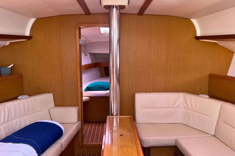  Yacht Photos Pics Interior of 2008 Jeanneau Sun Odyssey 42i Performance yacht with cozy seating and wood finish.
