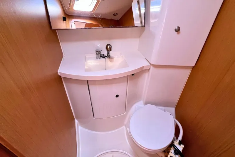 Yacht Photos Pics Compact bathroom in 2008 Jeanneau Sun Odyssey 42i Performance yacht, featuring sink and toilet.
