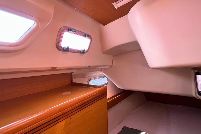  Yacht Photos Pics Interior cabin of 2008 Jeanneau Sun Odyssey 42i Performance sailboat, featuring wooden accents and windows.