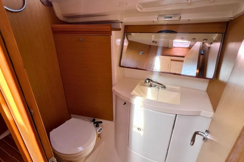  Yacht Photos Pics 2008 Jeanneau Sun Odyssey 42i Performance yacht bathroom with sink, mirror, and toilet.