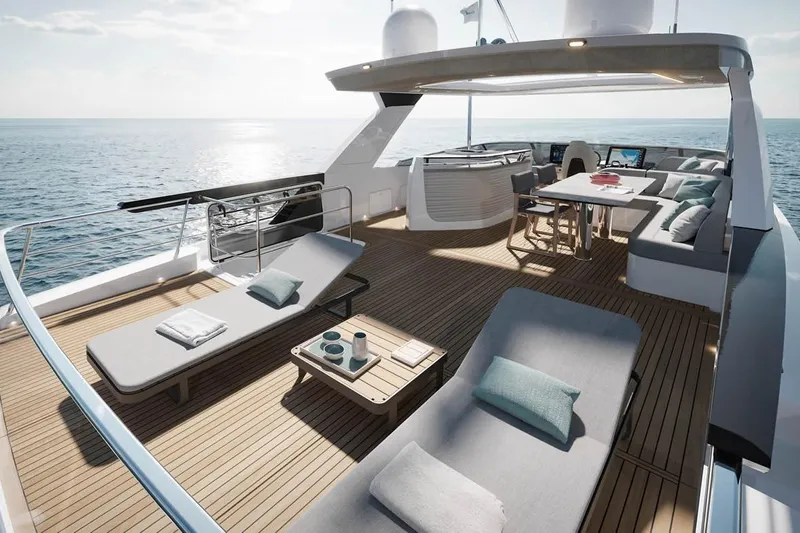  Yacht Photos Pics Luxurious 2026 Absolute Navetta 66 yacht deck with sun loungers and dining area at sea.