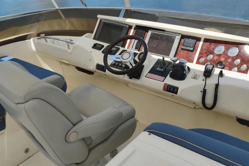  Yacht Photos Pics Cockpit of 2001 Viking Princess 72 yacht with steering wheel and navigation controls.