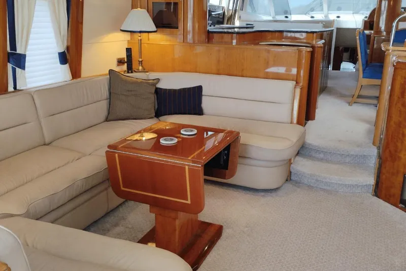  Yacht Photos Pics Luxurious interior of 2001 Viking Princess 72 yacht with elegant seating and wooden accents.